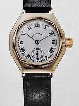 Vintage 1926 Rolex Oyster watch with a black leather strap and white dial.