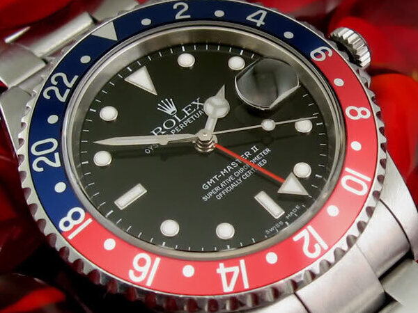 Rolex GMT-Master II Ref. 16710 "Pepsi" with a stainless steel oyster bracelet and black dial, featuring a red and blue bezel.