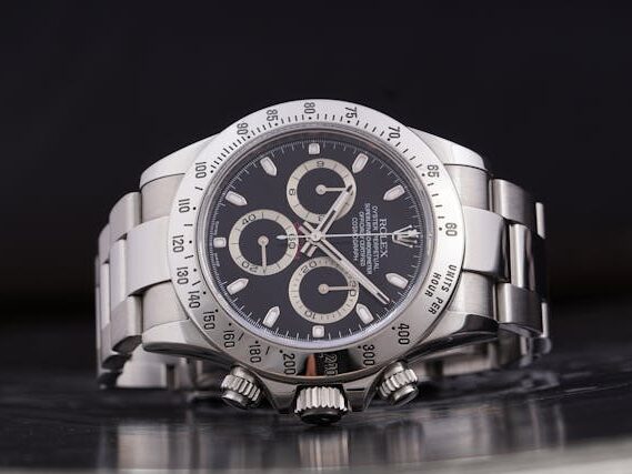 Close-up of a Rolex Daytona with a stainless steel bracelet and black dial.